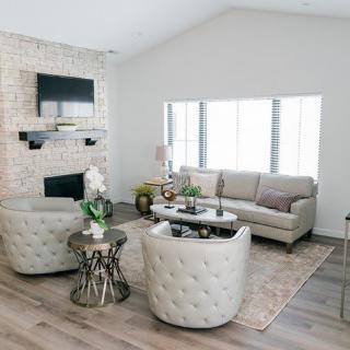 A modern living room with stylish furniture and a cozy fireplace.