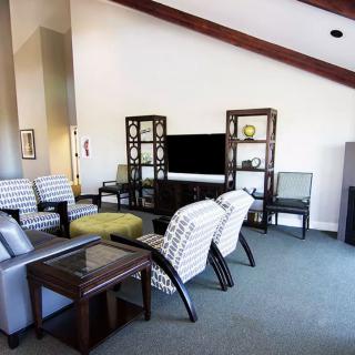 A modern living room with stylish furniture and a large television.