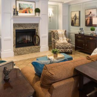 A cozy living room with a fireplace and stylish decor.
