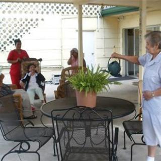 A group of people gathered on a patio enjoying each other's company.