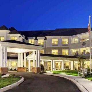 A well-lit hotel entrance at night.