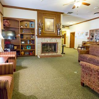 A cozy living room with a fireplace and comfortable seating.