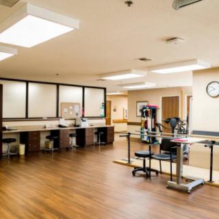 A well-equipped physical therapy room with modern exercise equipment.