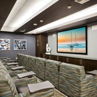 A modern home theater with comfortable seating and a large screen.