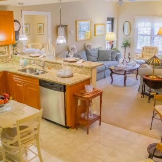 An open floor plan featuring a kitchen and living room with modern decor and comfortable furnishings.