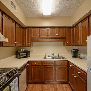 A cozy kitchen featuring wooden cabinets and modern appliances.