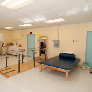 A physical therapy room equipped with rehabilitation tools and exercise equipment.