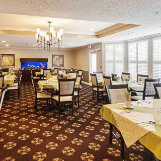 An elegantly decorated dining room with neatly arranged tables and a chandelier.