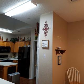 A cozy kitchen with wooden cabinets and modern appliances, adorned with home decor.