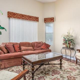 A cozy living room featuring a comfortable sofa, elegant coffee table, and decorative plants.