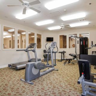 A well-equipped indoor gym with various fitness machines.
