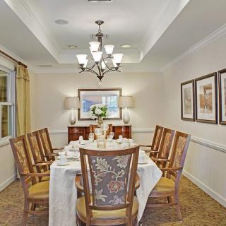 A well-decorated dining room with a large table set for a meal.