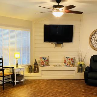 Cozy living room with modern decor and a flat-screen TV.