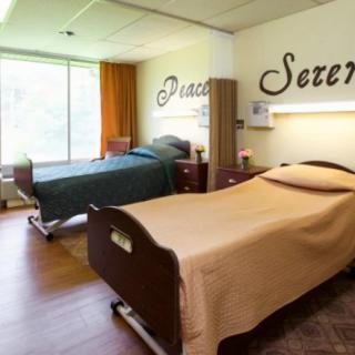 A calming hospital room with two neatly made beds, creating a serene and peaceful atmosphere.