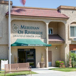 Entrance to Meridian of Riverside, showcasing the senior living community's building and signage.