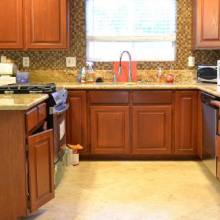 A well-organized kitchen with wooden cabinets and a bright window.