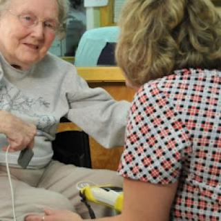 A warm interaction between an elderly woman and her caregiver.