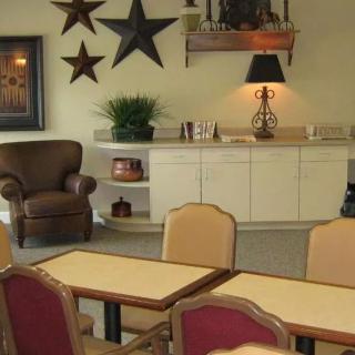 Cozy lounge area with chairs, tables, and decorative elements.