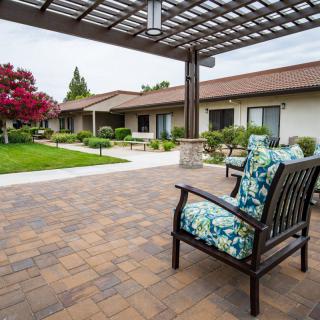 A tranquil courtyard with outdoor seating and lush landscaping.