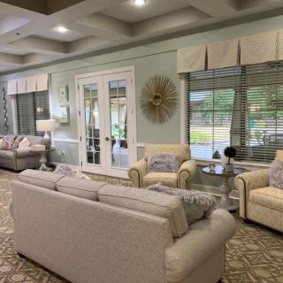 Bright and spacious living room with comfortable sofas and large windows.