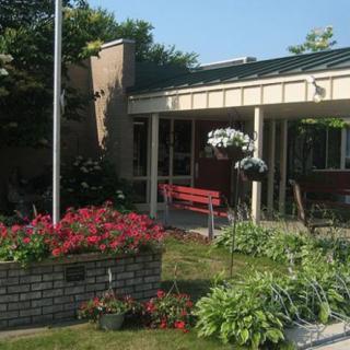 A charming garden with colorful flowers in front of a building.