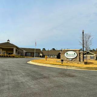 A welcoming entrance to a residential community, featuring landscaped grounds and clear signage.