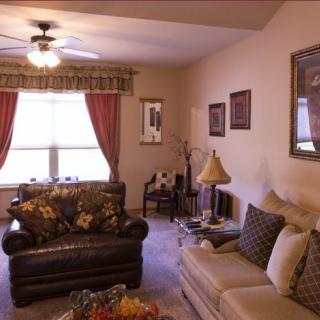 A cozy living room featuring comfortable seating, decorative pillows, and a warm ambiance.