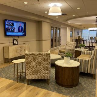 A modern lobby with comfortable seating and a television.