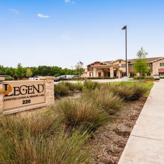 A modern healthcare facility with landscaped surroundings and a prominent entrance sign.