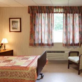 A cozy room with a hospital bed and traditional decor.