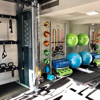A well-equipped gym with various exercise tools and fitness equipment.