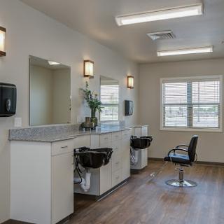 A clean and modern salon interior featuring styling stations and mirrors.