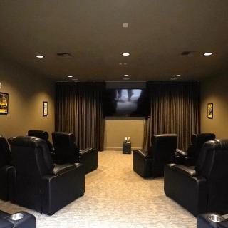 A cozy home theater with comfortable seating and a large screen.