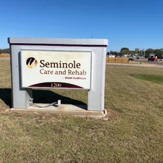 A sign indicating the Seminole Care and Rehabilitation facility in a grassy area.