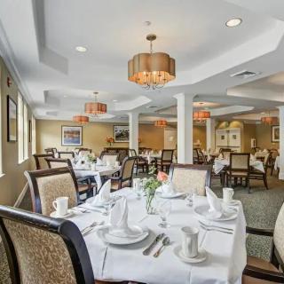 Elegant dining room with neatly set tables and ambient lighting.
