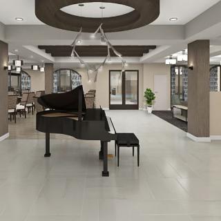A modern lobby featuring a grand piano as its centerpiece.