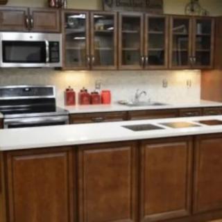 Modern kitchen with wooden cabinets and stainless steel appliances.