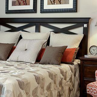 A cozy and elegant bedroom with a neatly arranged bed and stylish decor.