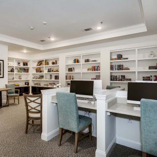 A quiet library space equipped with computers and bookshelves, offering a comfortable study area.