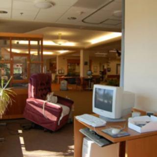 A cozy waiting room with a vintage computer and comfortable seating.