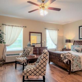 A cozy bedroom with elegant furnishings and natural lighting.