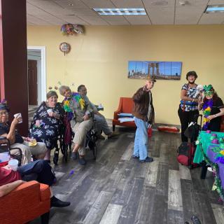 A cheerful gathering with people enjoying a party in a decorated indoor setting.