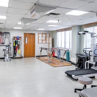 A well-equipped gym space designed for fitness and rehabilitation activities.