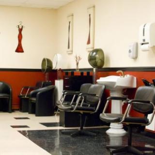 Interior of a hair salon with chairs, washing stations, and wall decor.