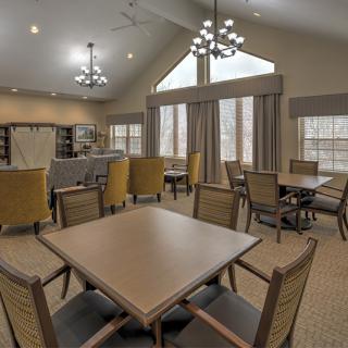 A spacious dining area with modern furniture and large windows providing ample natural light.