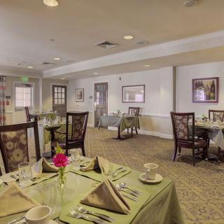 An elegantly set dining room with neatly arranged tables and chairs.