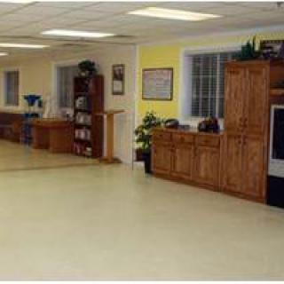 A spacious indoor area featuring wooden kitchen cabinets and ample flooring space.