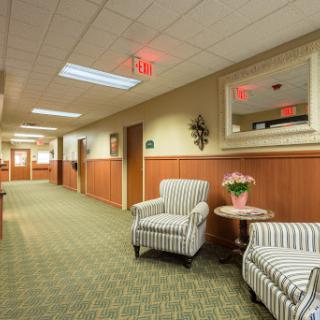 A welcoming hallway featuring comfortable seating and decorative elements.