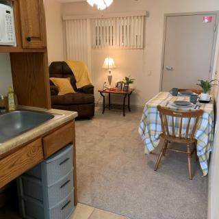 A cozy living space with a small kitchen and dining area.