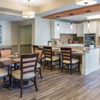 Modern kitchen and dining area with stylish furnishings and lighting.